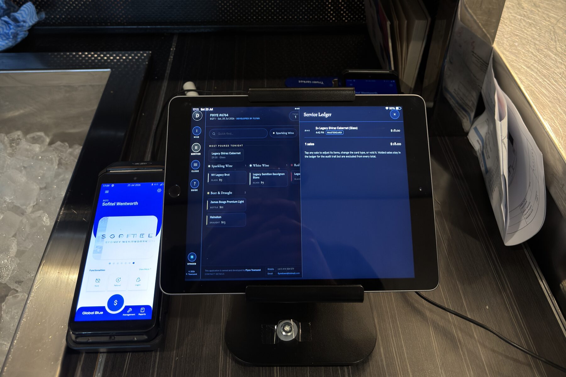 Service Ledger panel open on the iPad during a function, EFTPOS terminal alongside