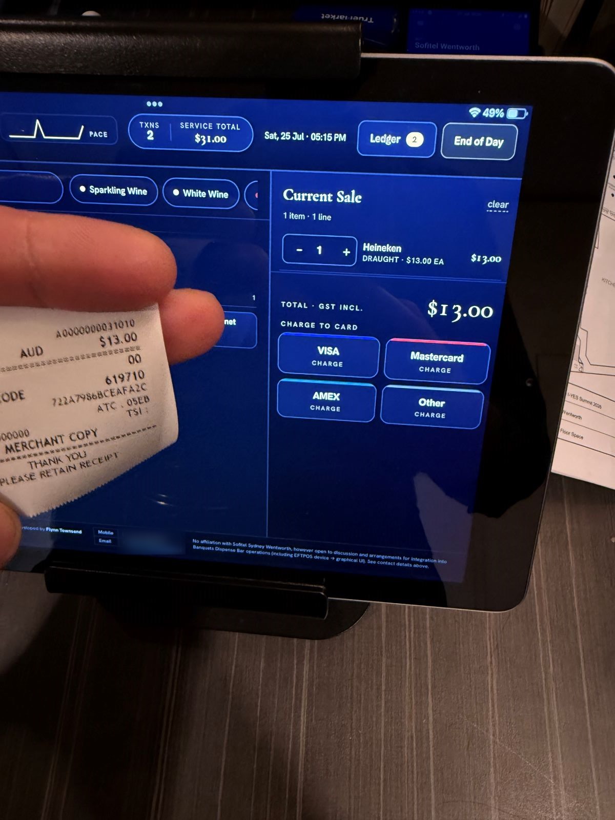 Tracker showing a $13.00 sale held against the matching printed EFTPOS merchant copy