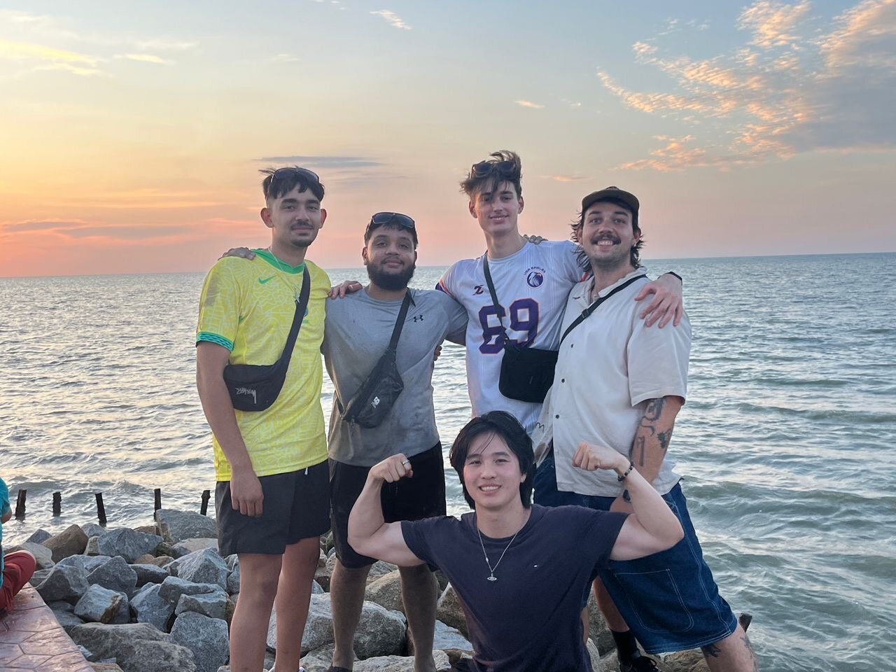 Part of the cohort at the water's edge at sunset